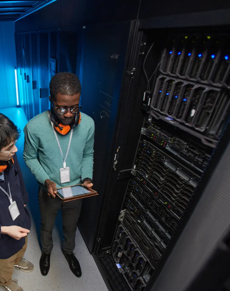 Technician auditing infrastructure with a tablet for a Python technology assessment in Houston