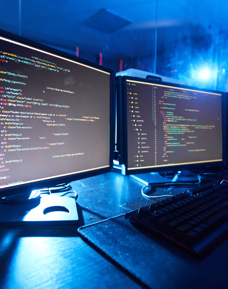 Custom Drupal module development code on dual monitors at DESSS