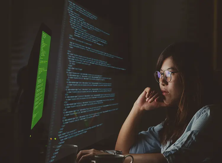 Tableau Business Intelligence Consulting in Houston Tableau Business Intelligence Consulting in Houston: developer reviewing code in a dark room